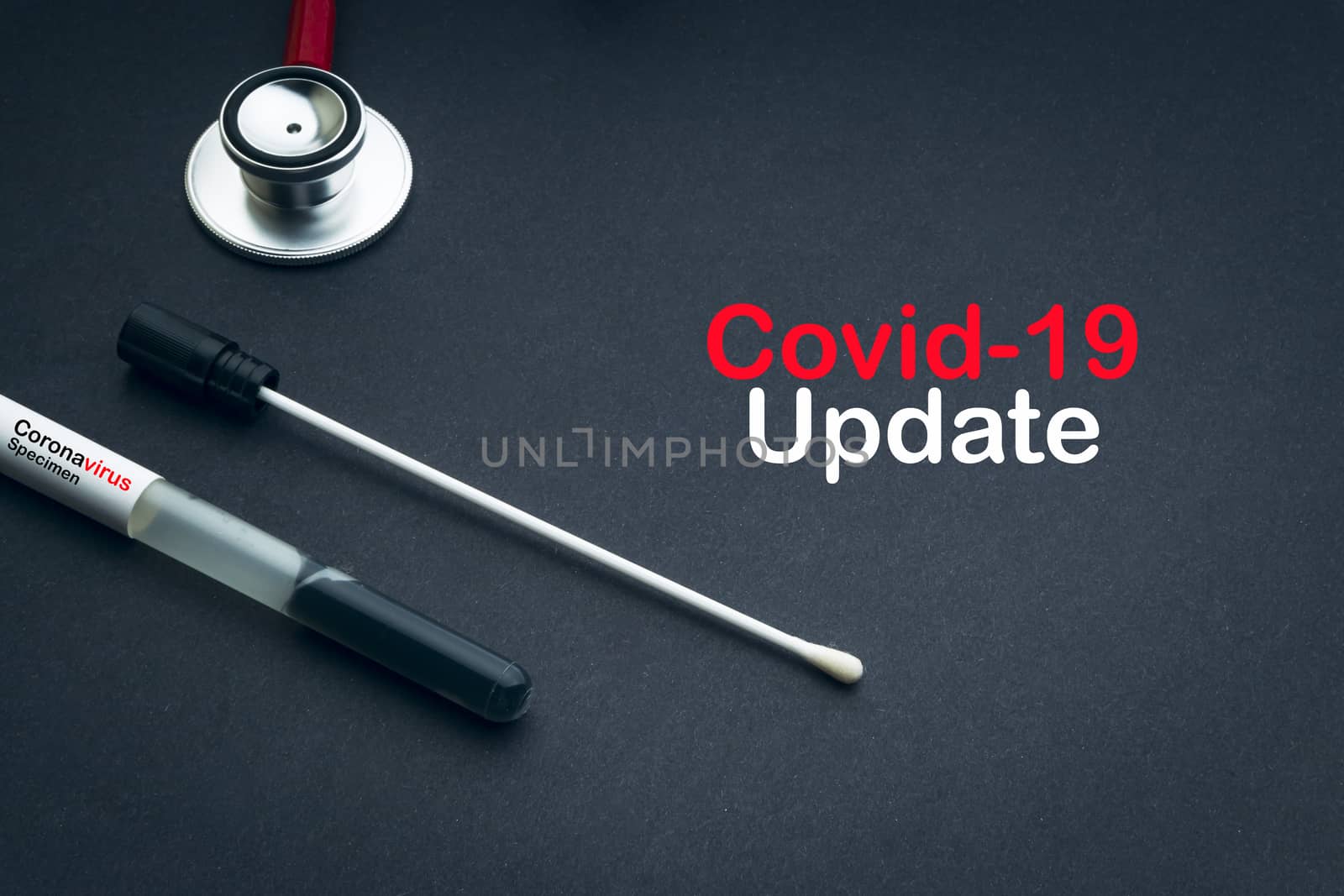 COVID-19 UPDATE text with stethoscope and medical swabs on black background. Covid -19 or Coronavirus Concept 