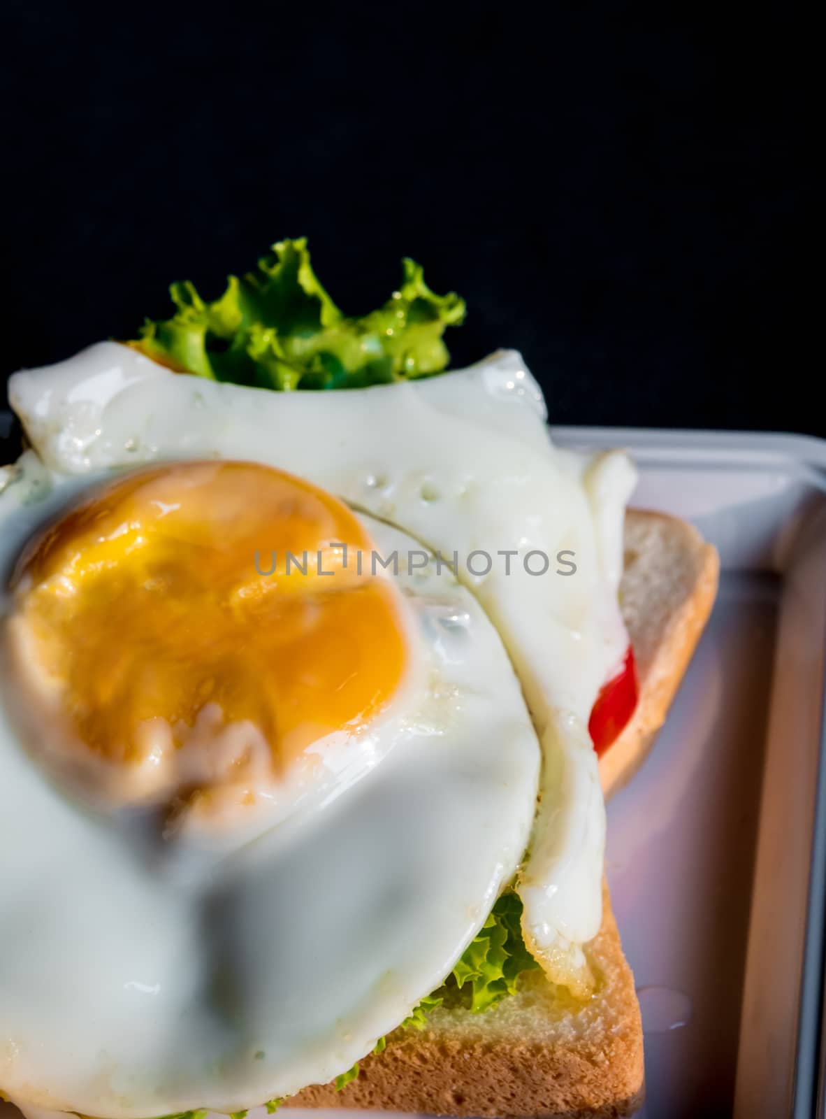 Fried egg and vegetable on sandwich bread by Satakorn