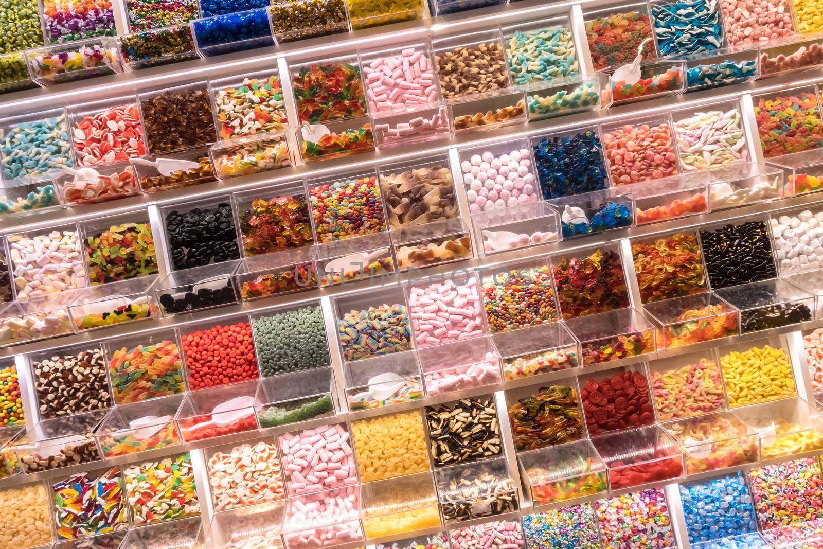 Candy display on a market. Various sweets for self-service.
