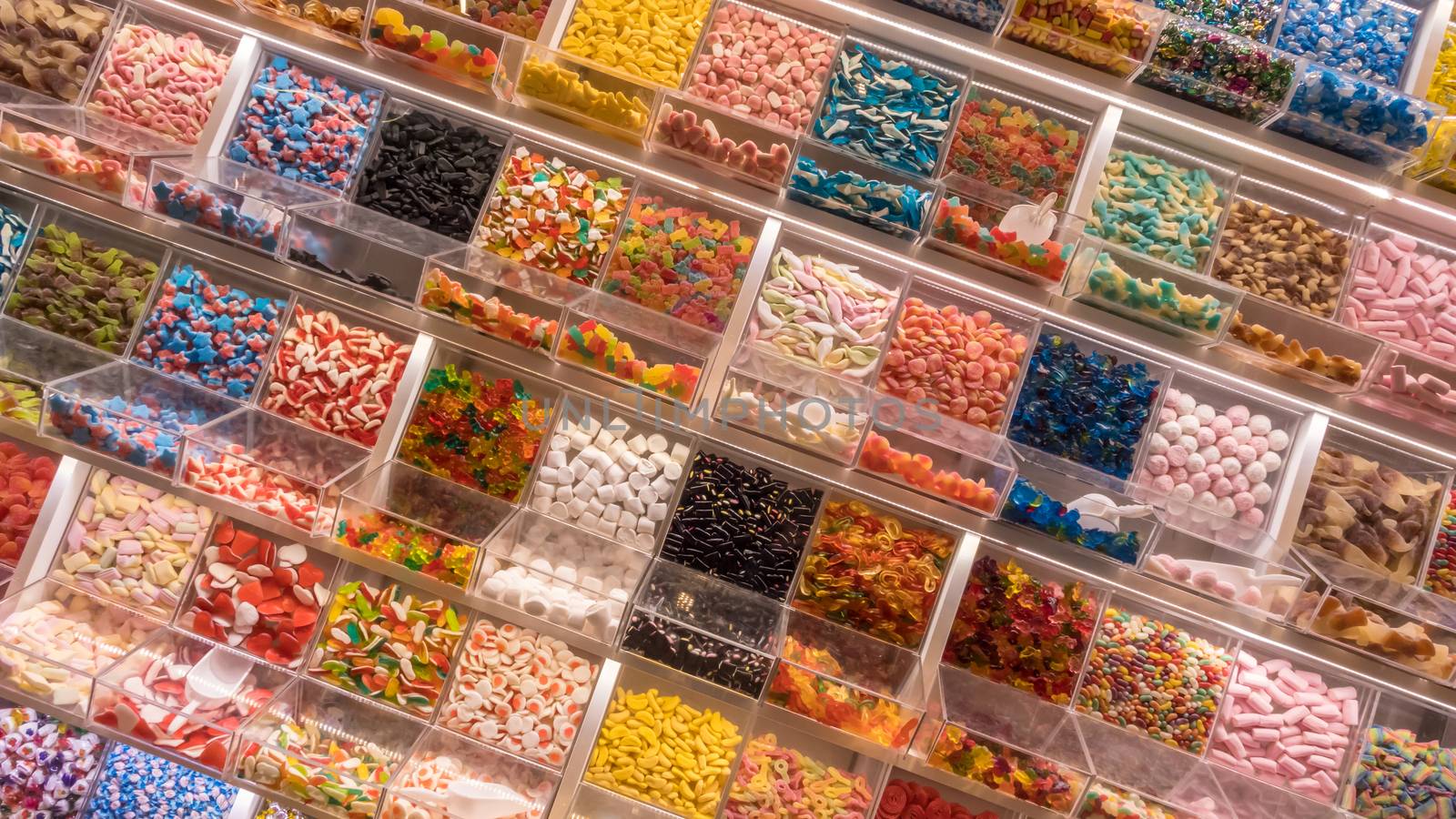 Candy display on a market. Various sweets for self-service.
