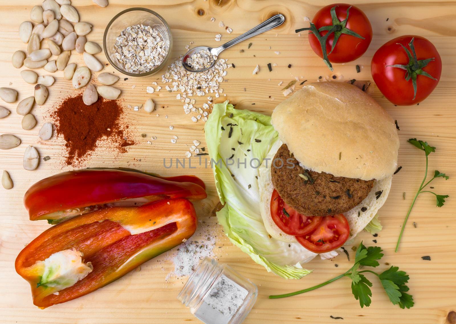 Homemade veg burger with ingredients, on a light wooden background. Top view.