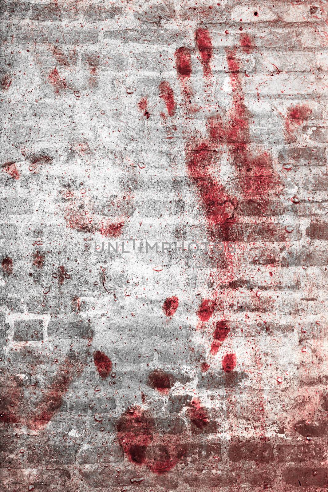 Bloody handprints and blotches of blood on grunge wall. Background for spooky content, halloween and more.