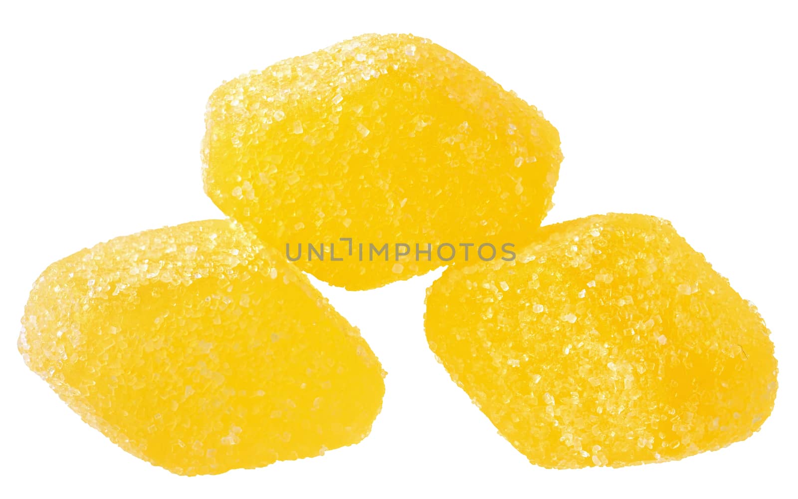 Handful of yellow candy close up on a white background.