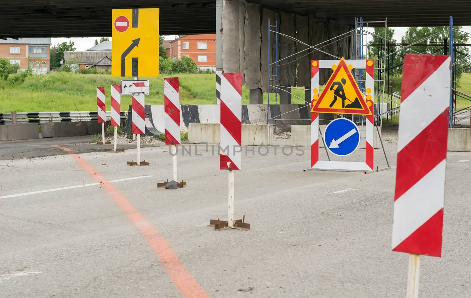 Road signs, detour, repair of the road on the asphalt bypass road near the residential area