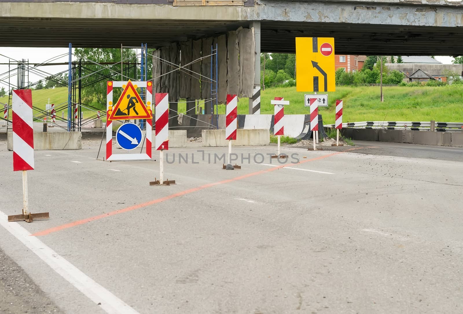 Road signs, detour, repair of the road on the asphalt bypass road near the residential area