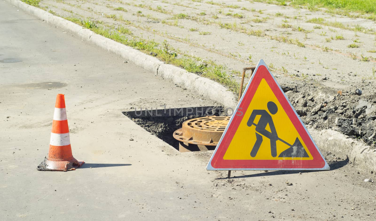 signs of road repair and sidewalk
