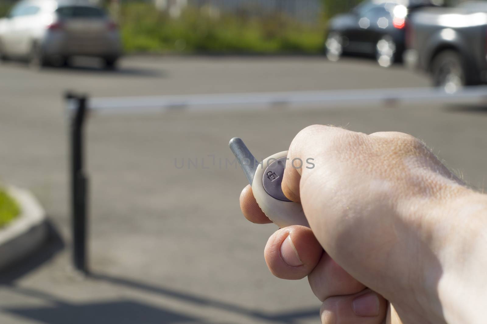 man with remote control automatic barrier opens