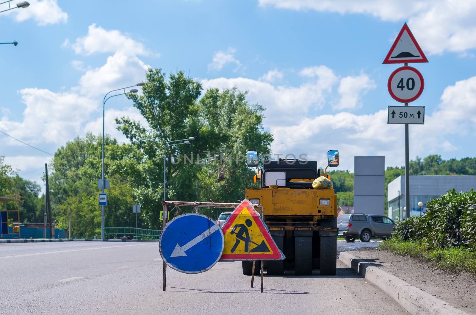 Signs stop, detour, road repair on the highway and road techniques