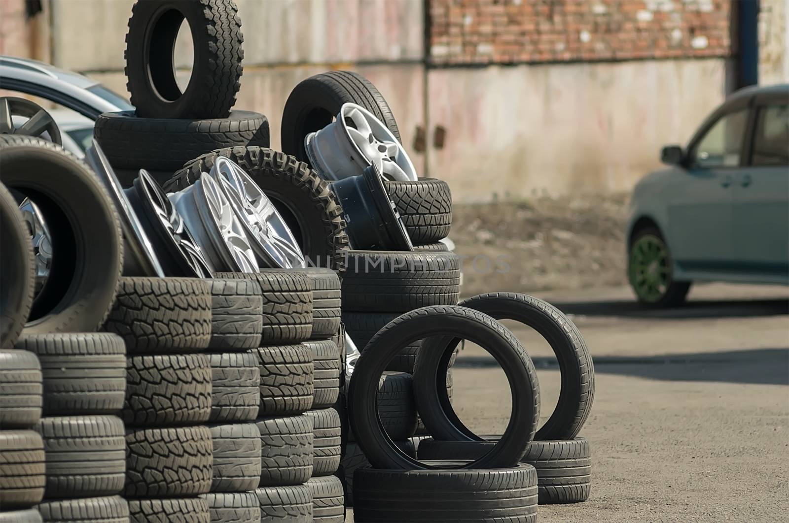 car tires with wheels laid on the street for sale in the industrial area by jk3030