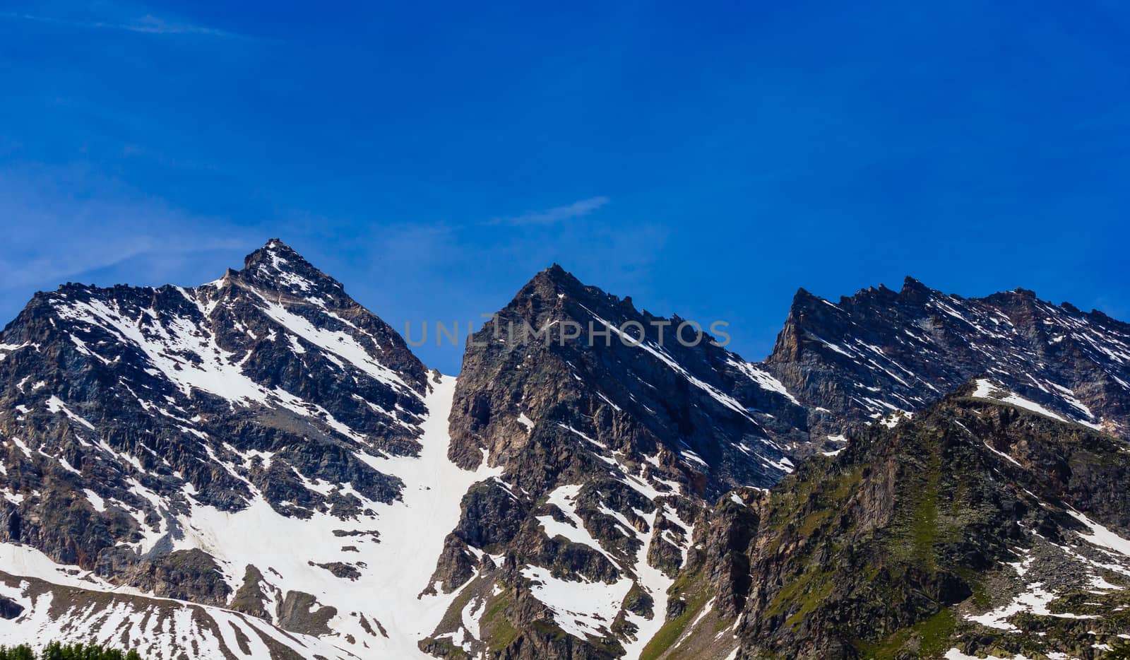 at the beginning of summer the mountains Three Leavanne with their 3500 metres height,are covered with snow