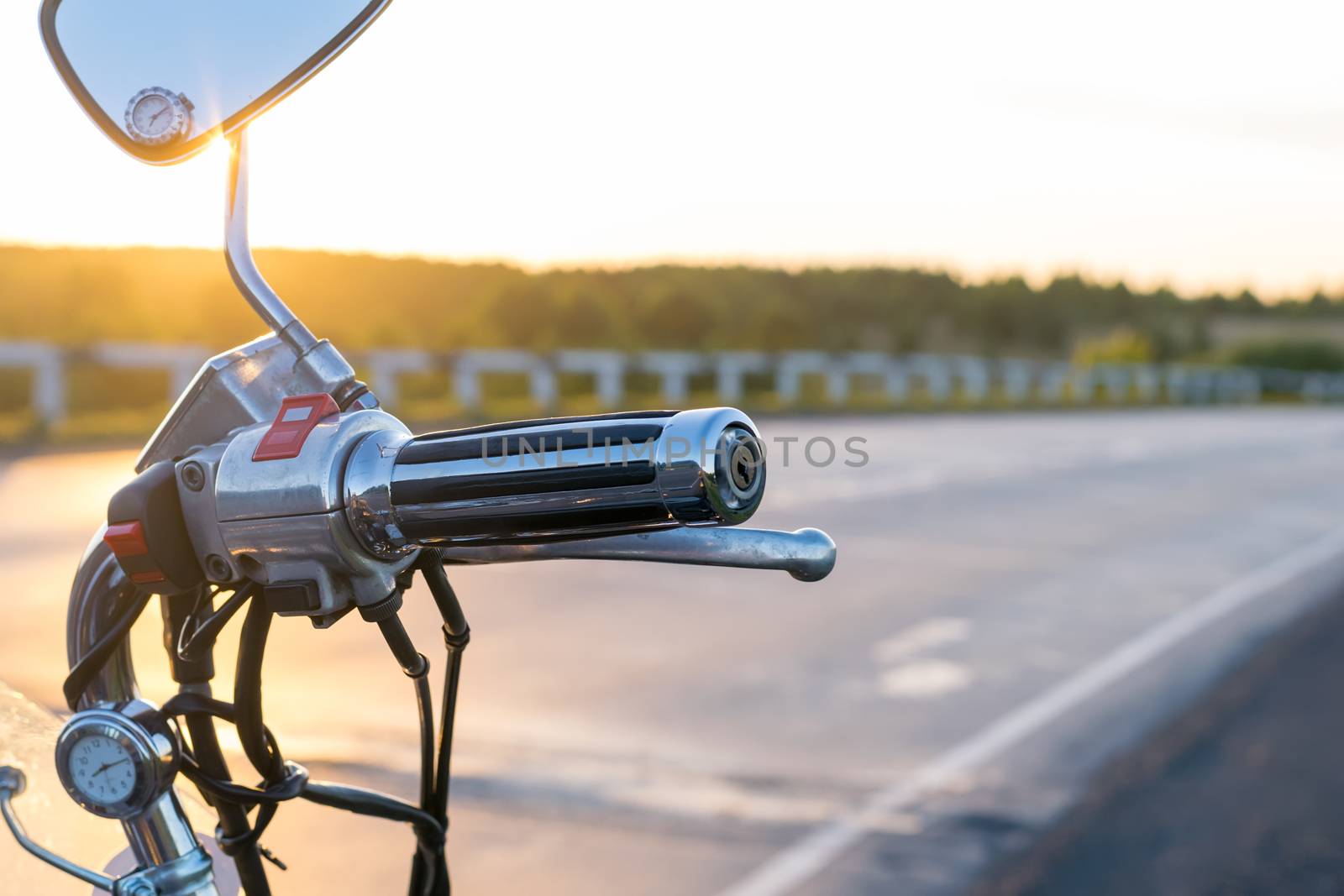 view of handlebar grips of the motorcycle on the country road background closeup by jk3030