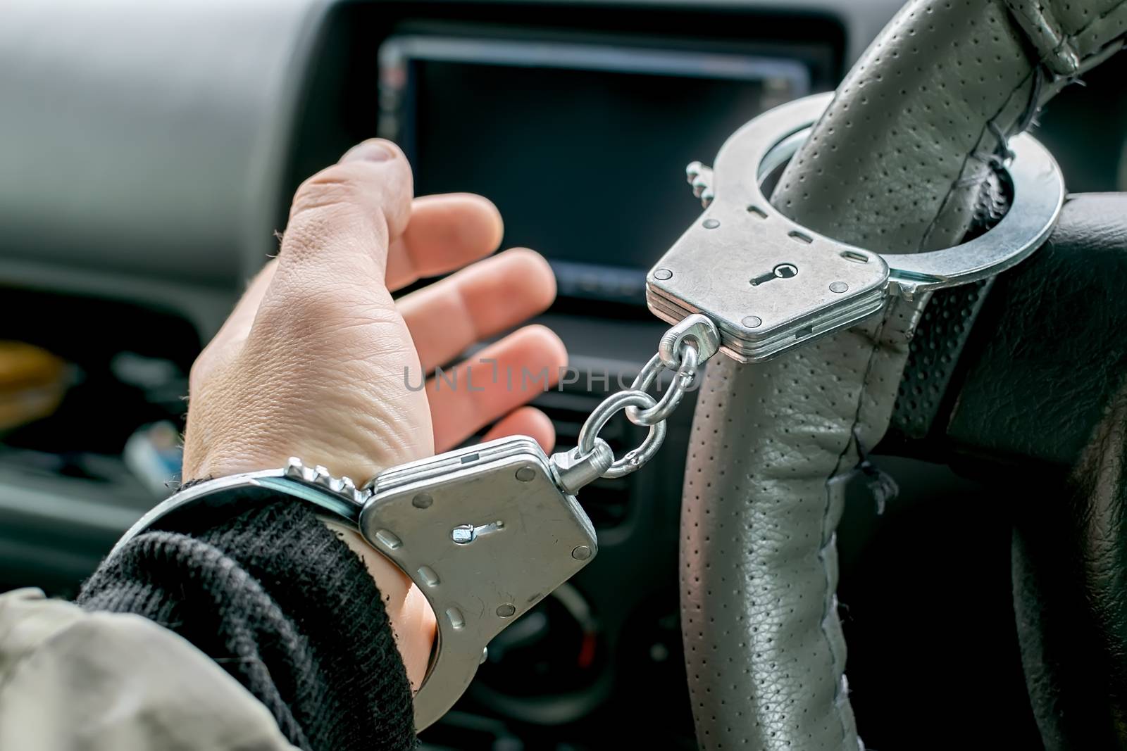 car driver's hand handcuffed to steering wheel, arrest, driving ban by jk3030
