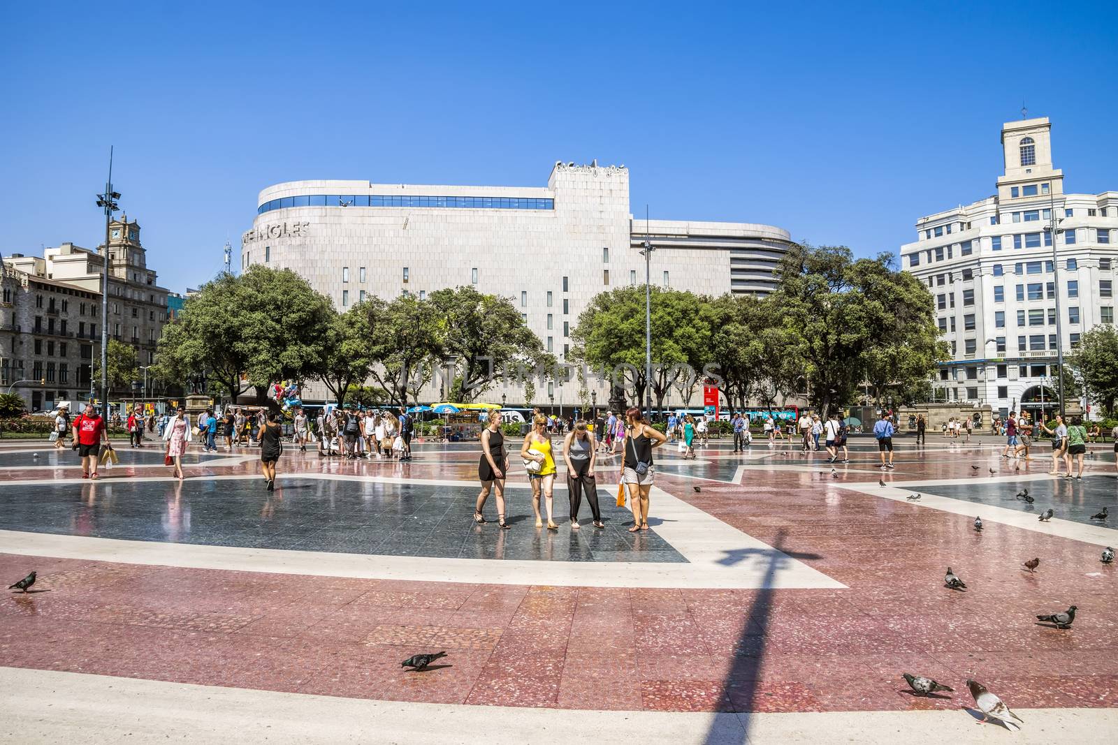 BARCELONA, SPAIN - JULY 5, 2016: View of Square of Catalonia (Placa de Catalunya) in Barcelona, Spain.

Barcelona, Spain - July 5, 2016:  View of Square of Catalonia (Placa de Catalunya) in Barcelona, Spain. Placa Catalunya is one of the most popular areas of Barcelona. It is located between the old town and the Eixample district. From Plaza Catalunya originate two most famous streets of Barcelona - Paseo Gracia and Rambla. People are walking by square.