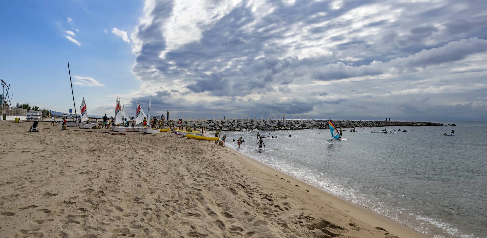 BARCELONA, SPAIN - JULY 13, 2016: People prepare yachts for surfing. Municipal Nautical Barcelona - surfing club for children and adult. Located in Park Poblenou, Barcelona, Spain.

Barcelona, Spain - July 13, 2016: People prepare yachts for surfing. Municipal Nautical Barcelona - surfing club for children and adult. Located in Park Poblenou, Barcelona, Spain.