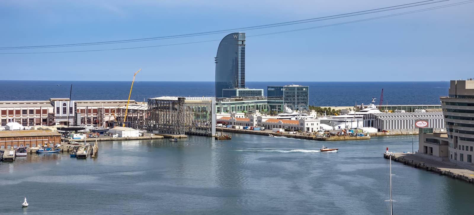 BARCELONA, SPAIN - JULY 4, 2016: Aerial view of Port Vell in Barcelona, Spain. It is the old harbor of Barcelona with an area of sports boats, dock and a shopping area.

Barcelona, Spain - July 4, 2016: Aerial view of Port Vell in Barcelona, Spain. It is the old harbor of Barcelona with an area of sports boats, dock and a shopping area.