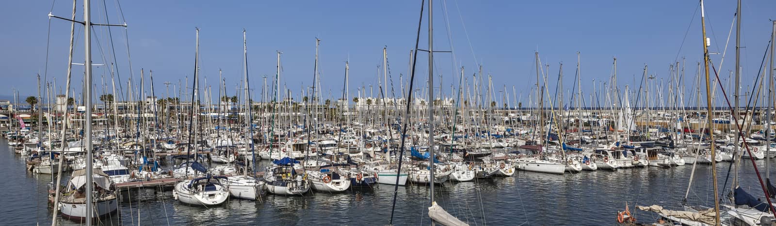 Yachts and sailboats moored in the Port Vell of Barcelona by Venakr