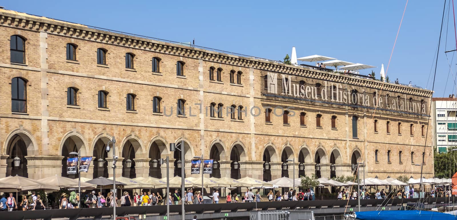 BARCELONA, SPAIN - JULY 4, 2016: Museum of History (Palau de Mar 1880-1890) in front of the harbor.

Barcelona, Spain - July 4, 2016: Museum of History (Palau de Mar 1880-1890) in front of the harbor. People are walking at the promenade.