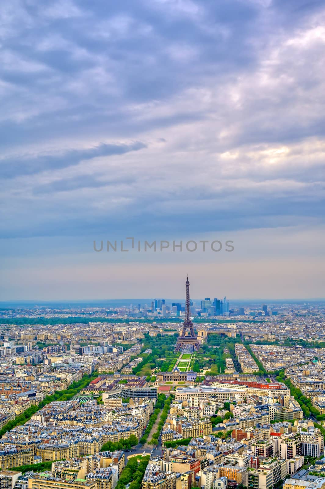 An aerial view of the Eiffel Tower and Paris, France at dusk.
