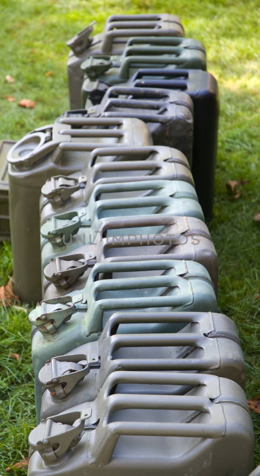 a row of WWII Jerry Cans in a field