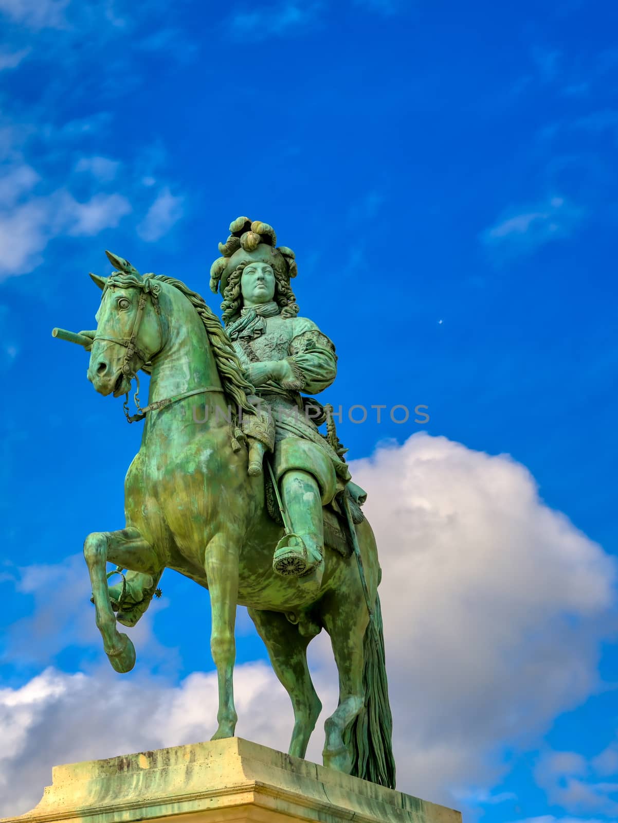 Versailles, France - April 24, 2019: Louis XIV statue just outside of the gates of Versailles Palace on a sunny day outside of Paris, France.