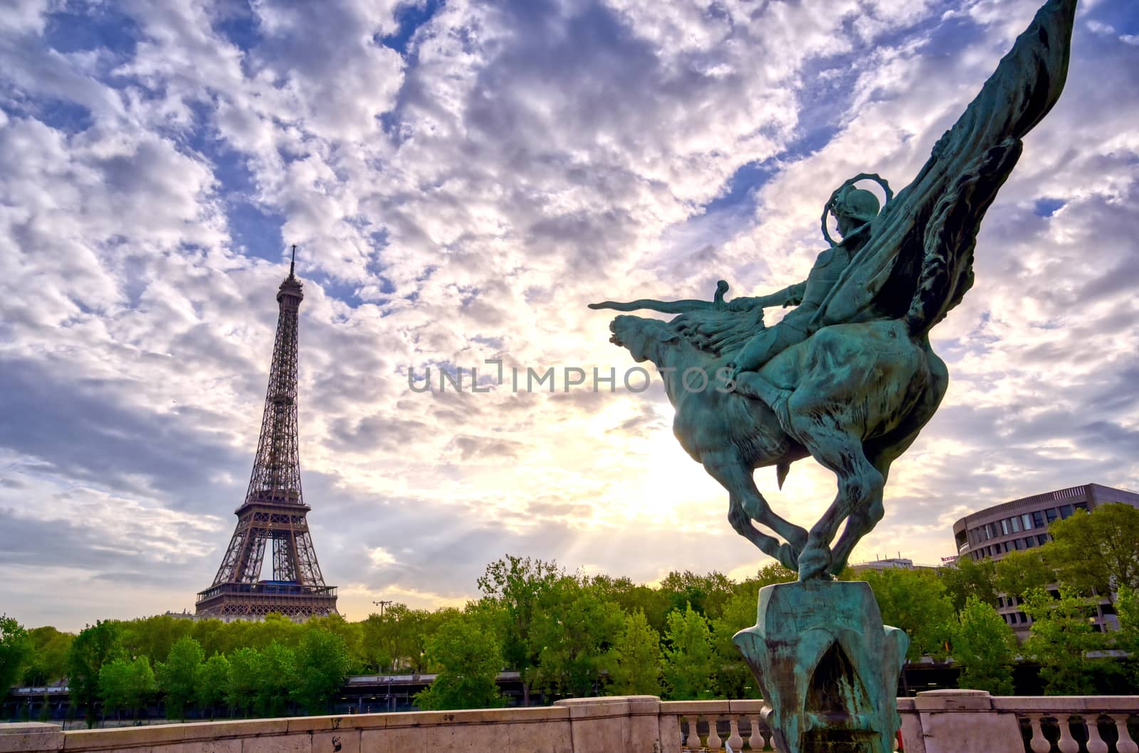The Eiffel Tower across the Seine River in Paris, France on a sunny day with beautiful clouds.