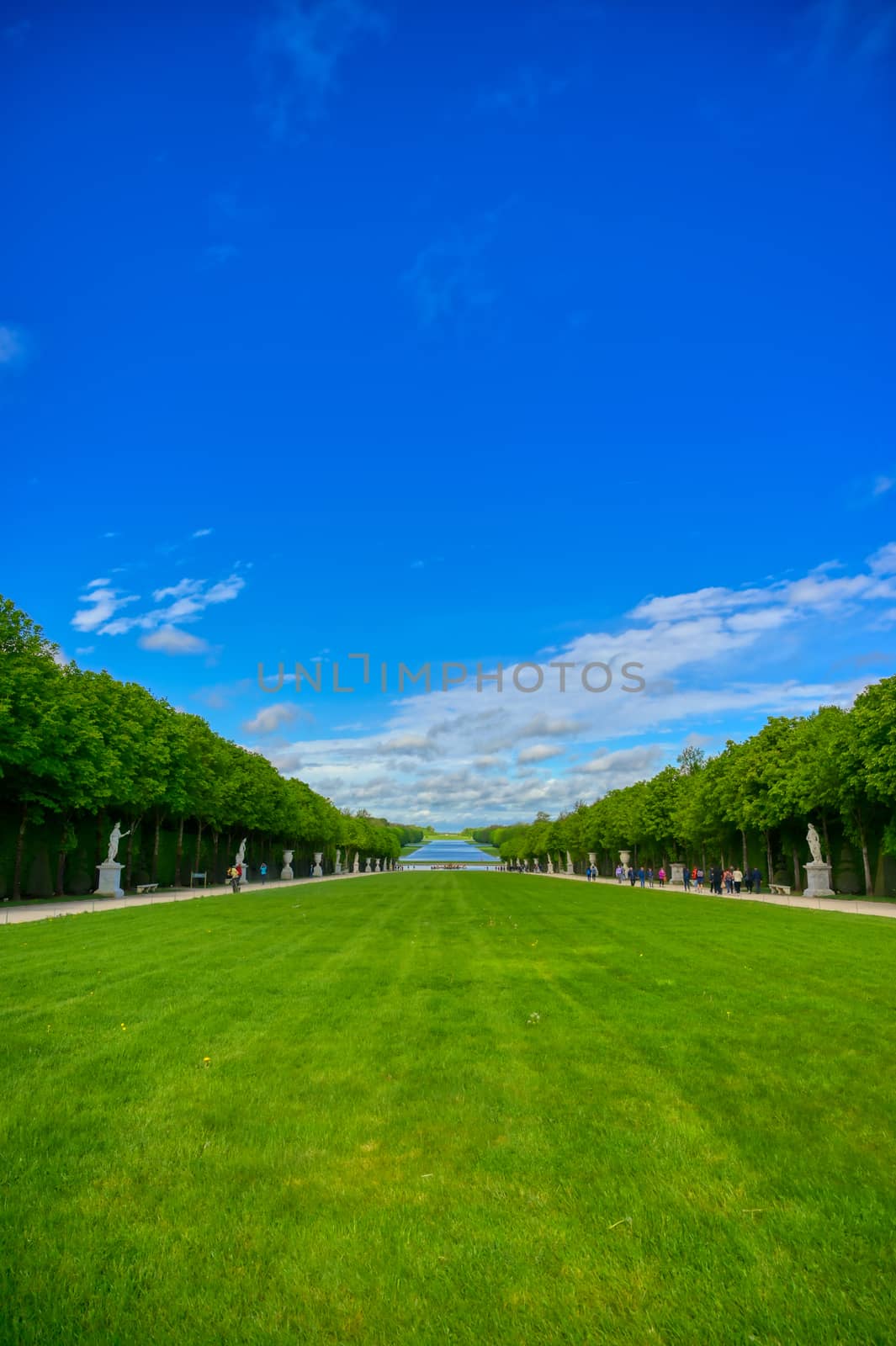 Versailles, France - April 24, 2019: The statues and fountains in and around the garden of Versailles Palace on a sunny day outside of Paris, France.