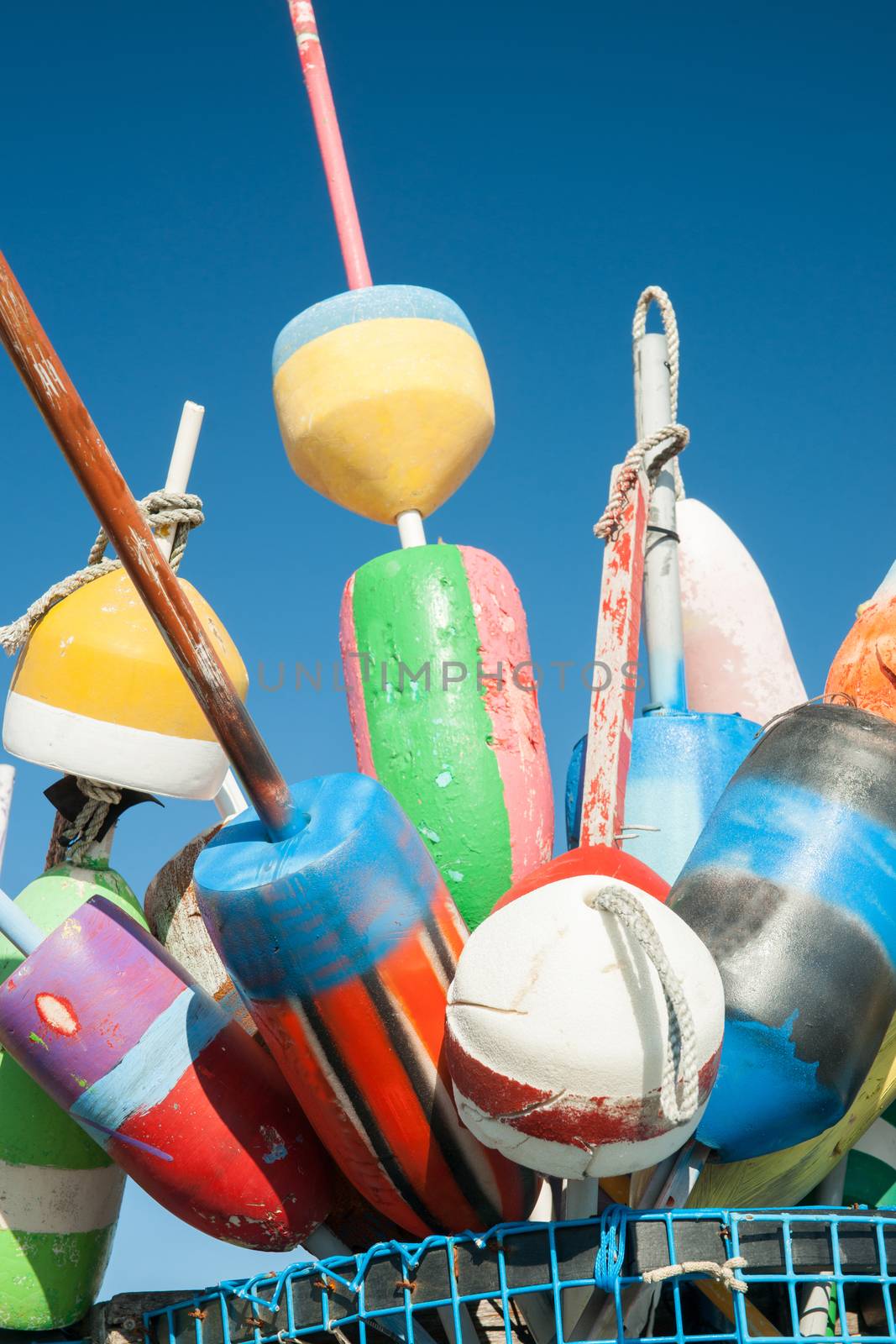 Collection of colorful fishing or lobster trap buoys and markers at wharf in Provincetown, Massachusetts, USA.