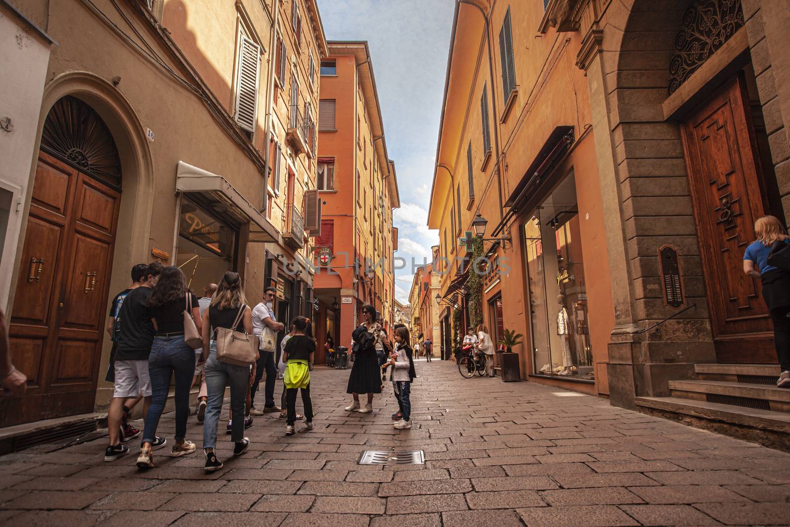 Alley of the city of Bologna in Italy with people walking 2 by pippocarlot