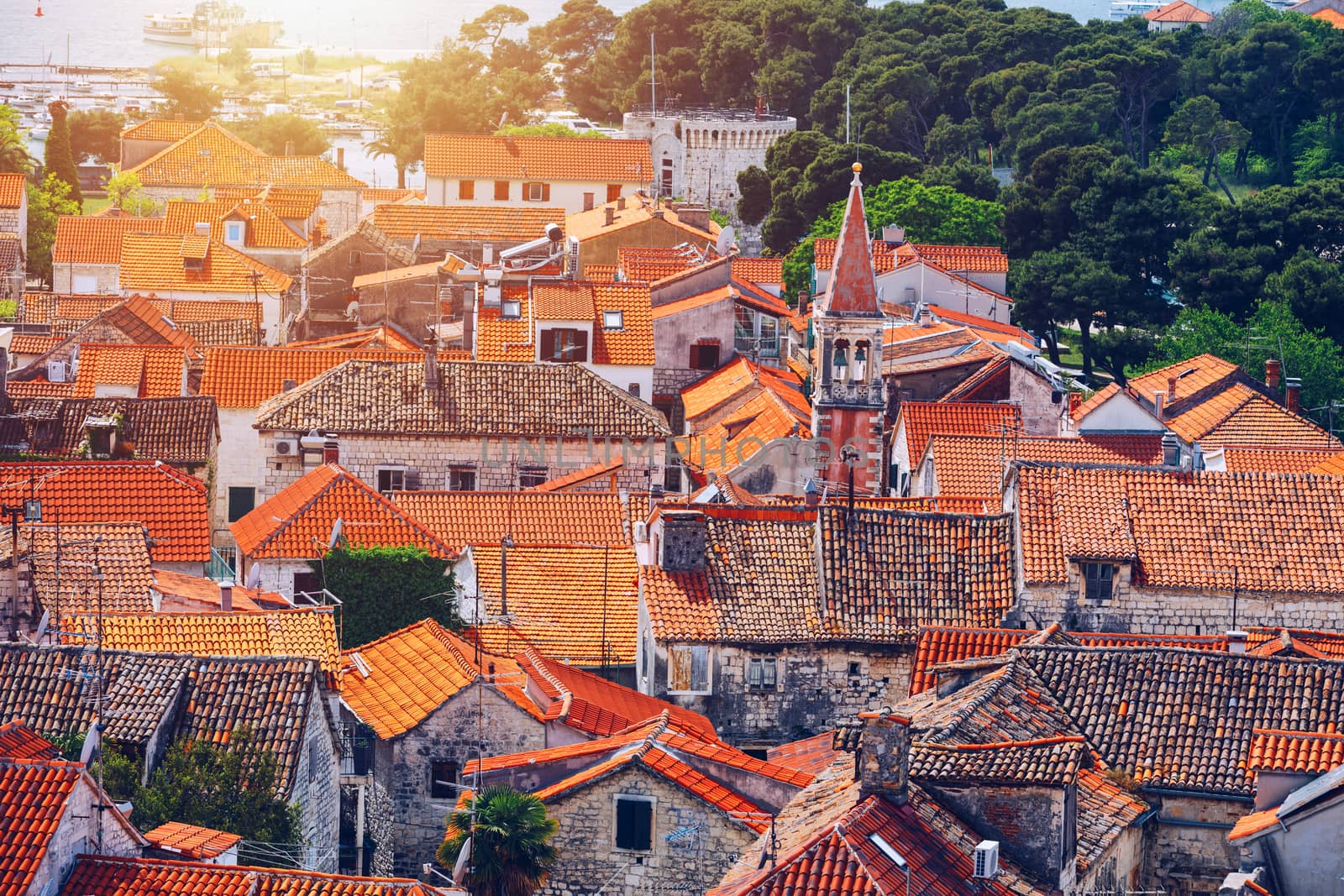 Trogir in Croatia, town panoramic view with red roof tiles, Croatian tourist destination. Trogir town sea front view, Croatia. Roofs of Trogir in Croatia.