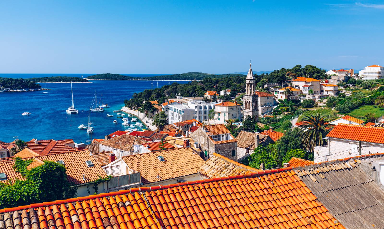 Panoramic view of Hvar town with lots of red roofs in Croatia. Hvar houses and roofs mediteranean town. Beautiful stacked houses in Hvar off the Dalmatian coast in Croatia.
