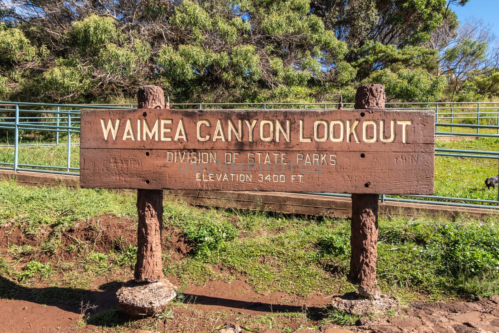 Brown wooden sign announcing lookout over Waimea Canyon, Kauai, by Claudine