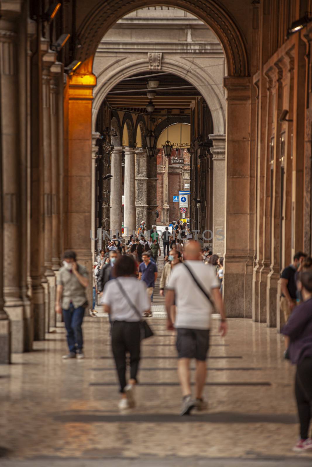 BOLOGNA, ITALY 17 JUNE 2020: People walking under arcades in Bologna, Italy