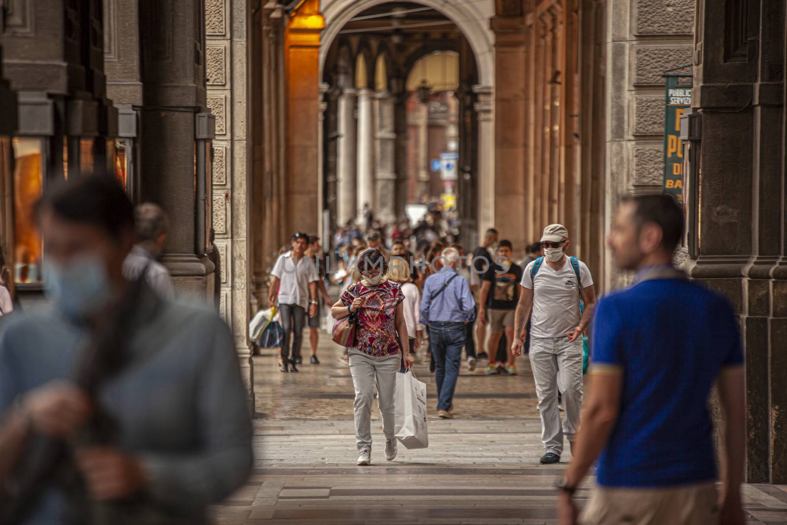 BOLOGNA, ITALY 17 JUNE 2020: People walking under arcades in Bologna, Italy