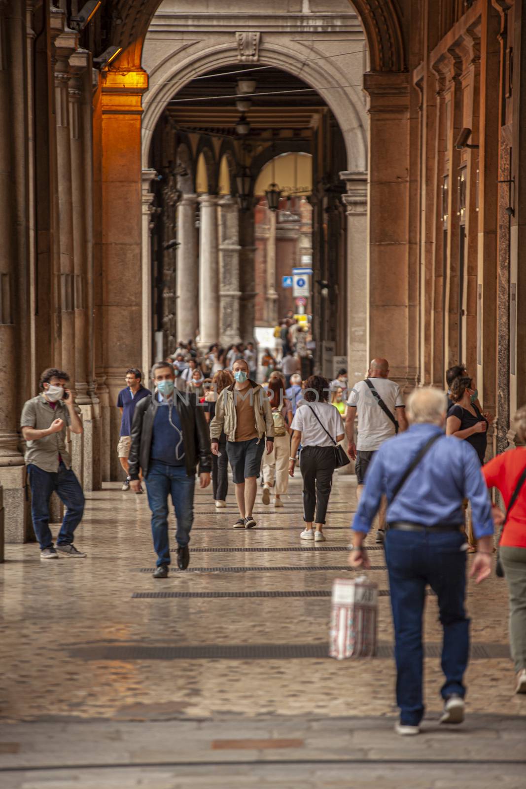 BOLOGNA, ITALY 17 JUNE 2020: People walking under arcades in Bologna, Italy