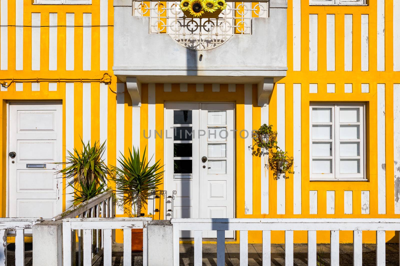 Street with colorful houses in Costa Nova, Aveiro, Portugal. Street with striped houses, Costa Nova, Aveiro, Portugal. Facades of colorful houses in Costa Nova, Aveiro, Portugal.