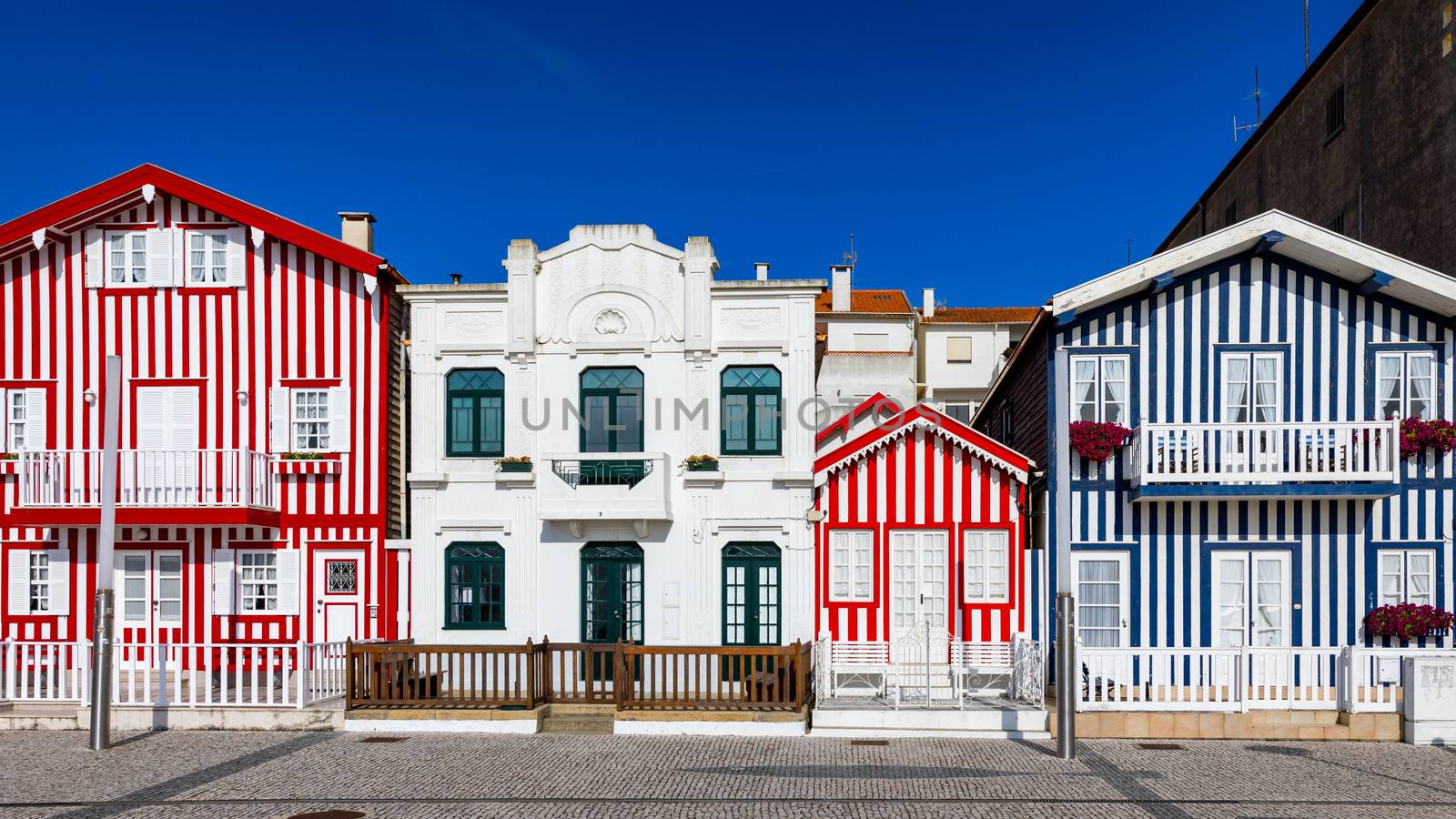 Street with colorful houses in Costa Nova, Aveiro, Portugal. Street with striped houses, Costa Nova, Aveiro, Portugal. Facades of colorful houses in Costa Nova, Aveiro, Portugal.