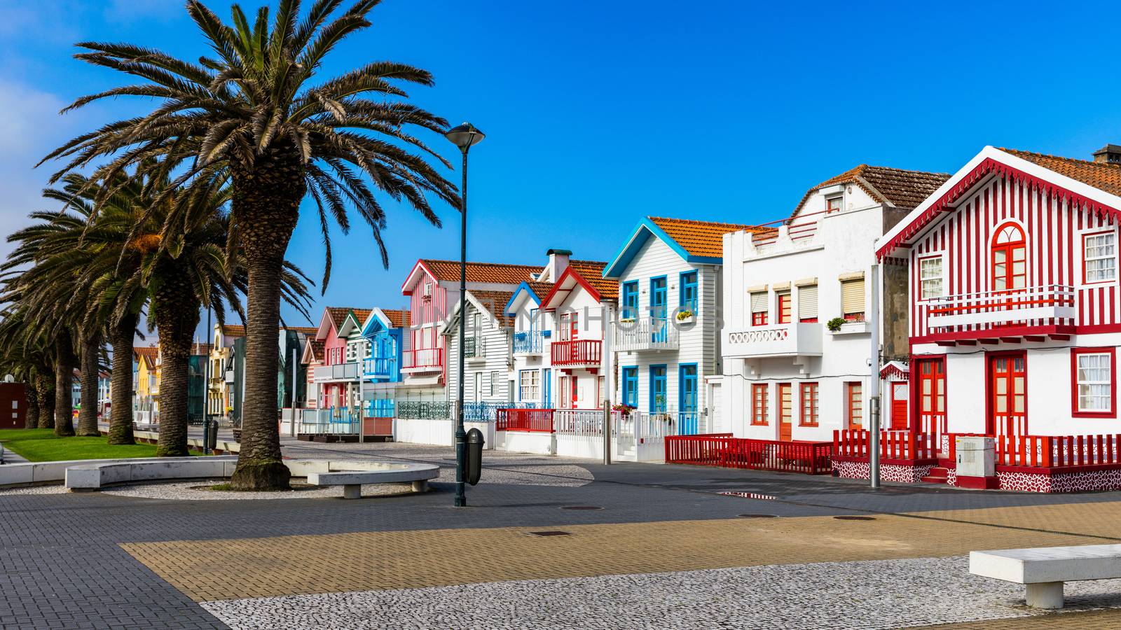 Street with colorful houses in Costa Nova, Aveiro, Portugal. Street with striped houses, Costa Nova, Aveiro, Portugal. Facades of colorful houses in Costa Nova, Aveiro, Portugal.
