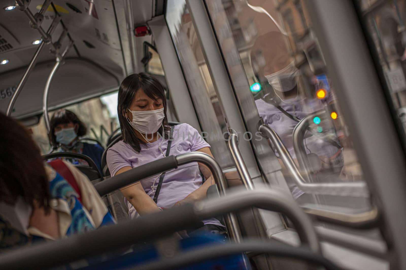 Girl in the bus with medical mask during Covid quarantine by pippocarlot
