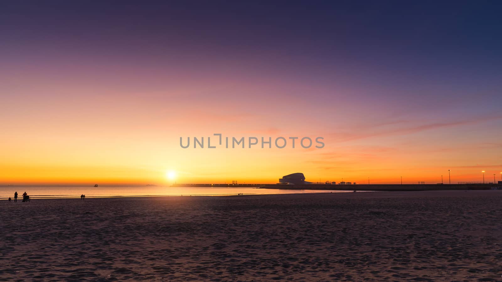 Beautiful sunset at Matosinhos beach in Porto, Portugal. Beautiful Atlantic ocean sparkling in the sun with birds in the air. Porto, Portugal.
