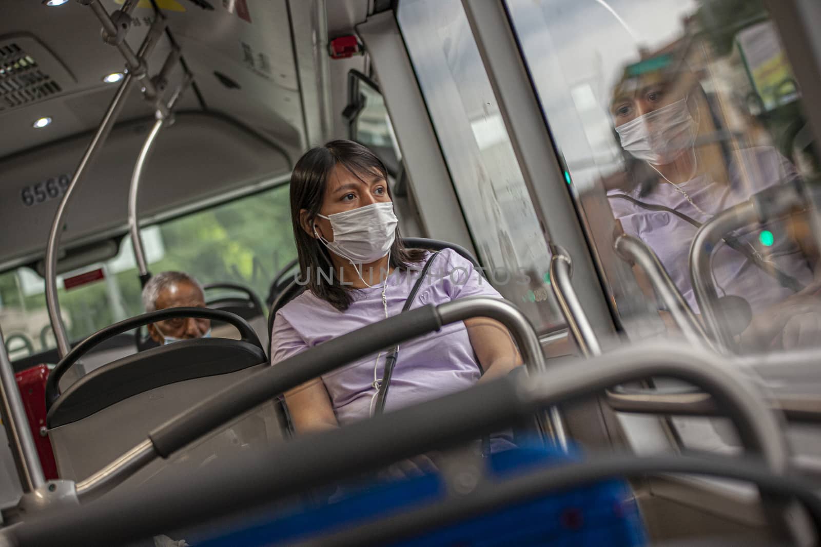BOLOGNA, ITALY 17 JUNE 2020: Girl in the bus with medical mask during Covid quarantine