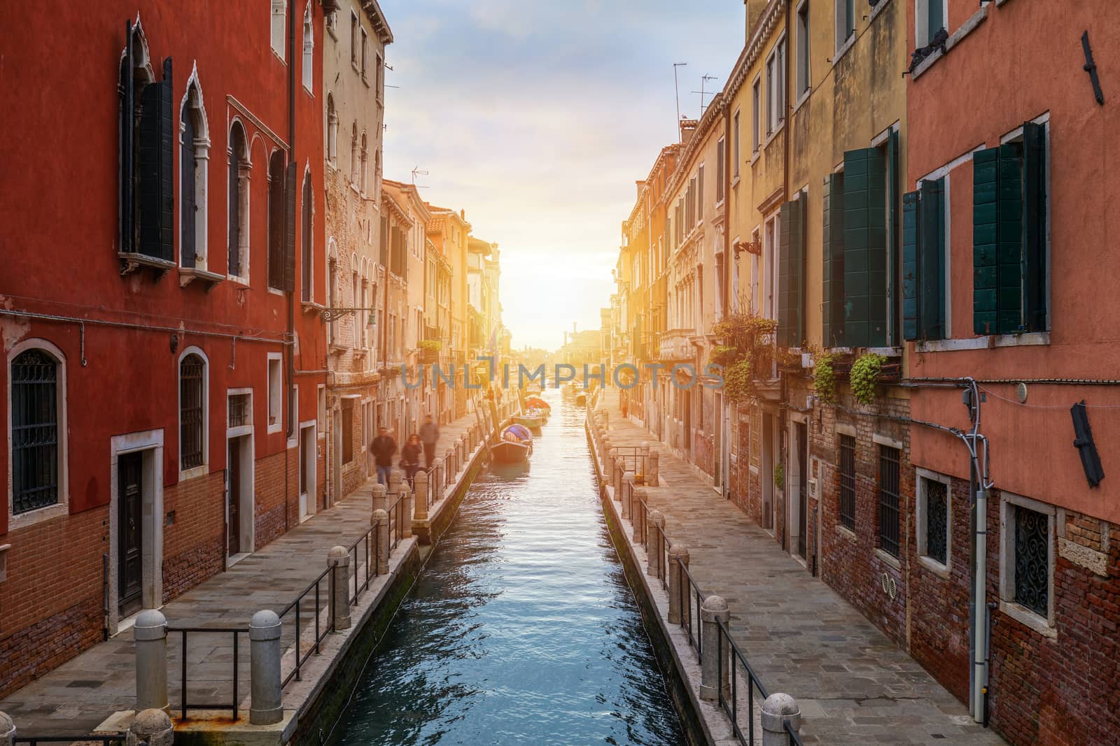 Street canal in Venice, Italy. Narrow canal among old colorful brick houses in Venice, Italy. Venice postcard