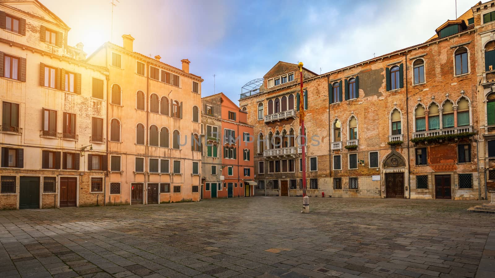 Street in Venice, Italy. Narrow street among old colorful brick houses in Venice, Italy. Venice postcard