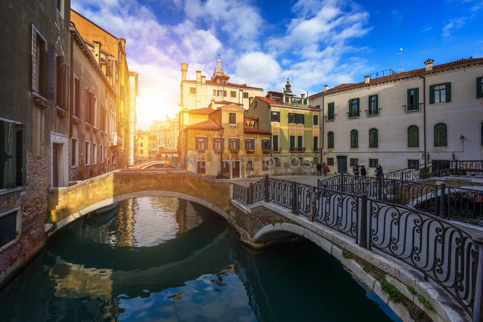 Street canal in Venice, Italy. Narrow canal among old colorful brick houses in Venice, Italy. Venice postcard