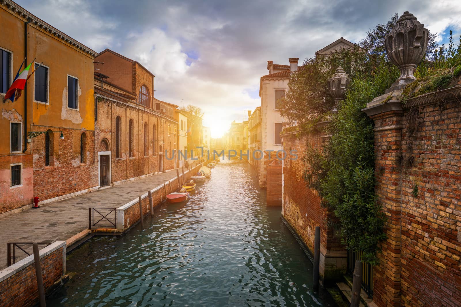 View of the street canal in Venice, Italy. Colorful facades of old Venice houses. Venice is a popular tourist destination of Europe. Venice, Italy.