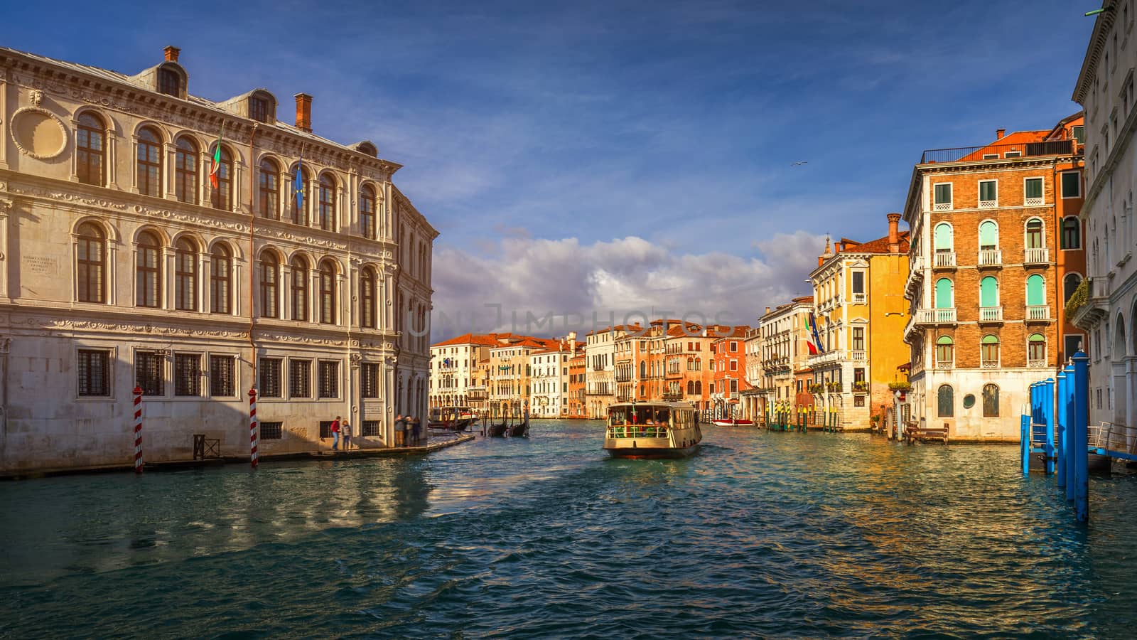 View of the street canal in Venice, Italy. Colorful facades of old Venice houses. Venice is a popular tourist destination of Europe. Venice, Italy.