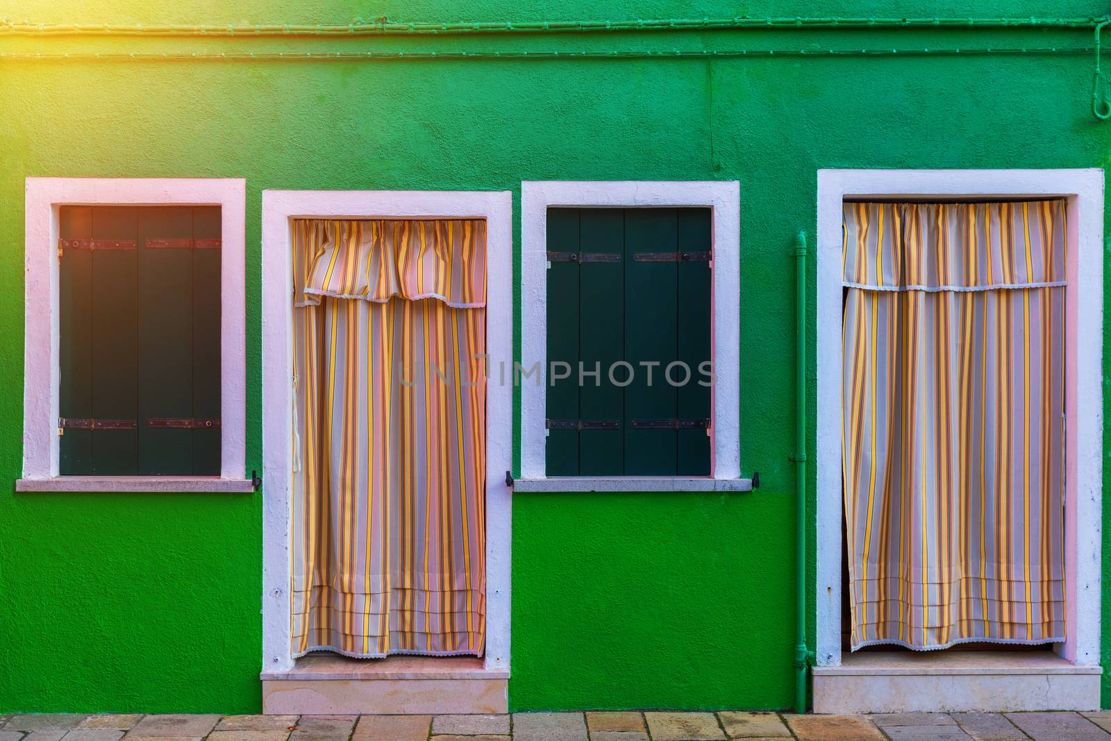 Lovely house facade and colorful walls in Burano, Venice. Burano island canal, colorful houses and boats, Venice landmark, Italy. Europe