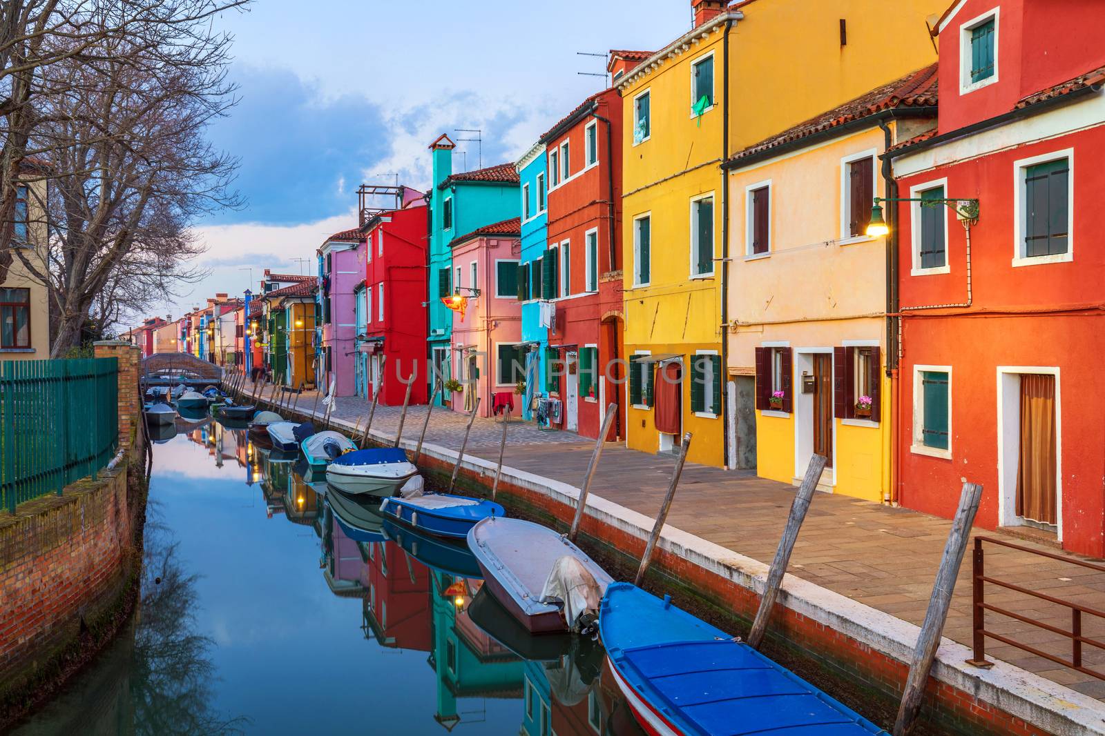 Beautiful view of the canals of Burano with boats and beautiful, colorful buildings. Burano village is famous for its colorful houses. Venice, Italy.