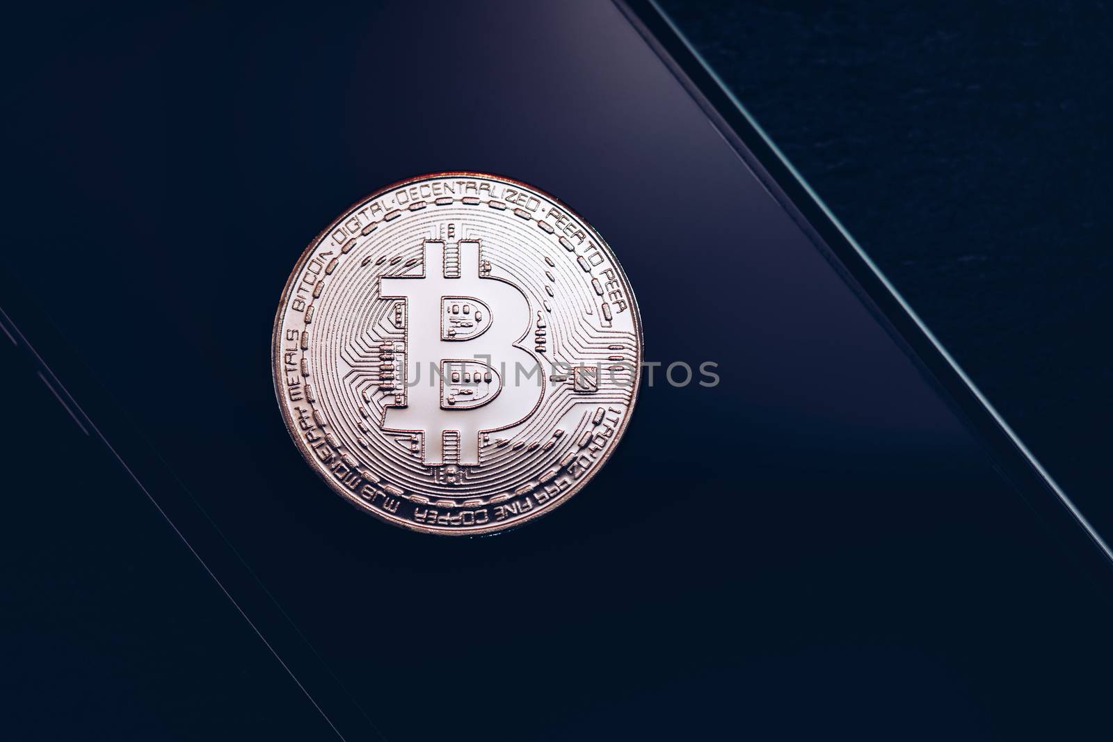 Bitcoin symbol over mobile screen, minimalist approach. Bitcoin on stock market. New digital money. Golden Bitcoin over smartphone display.