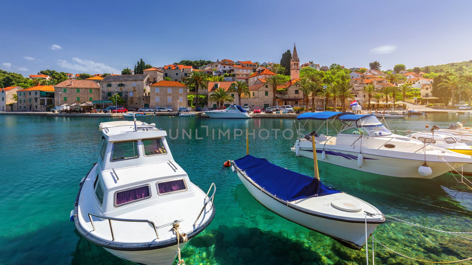 Fishing boats in Splitska village with beautiful port, Brac island, Croatia. Village of Splitska on Brac island seafront view, Dalmatia, Croatia, Croatia.