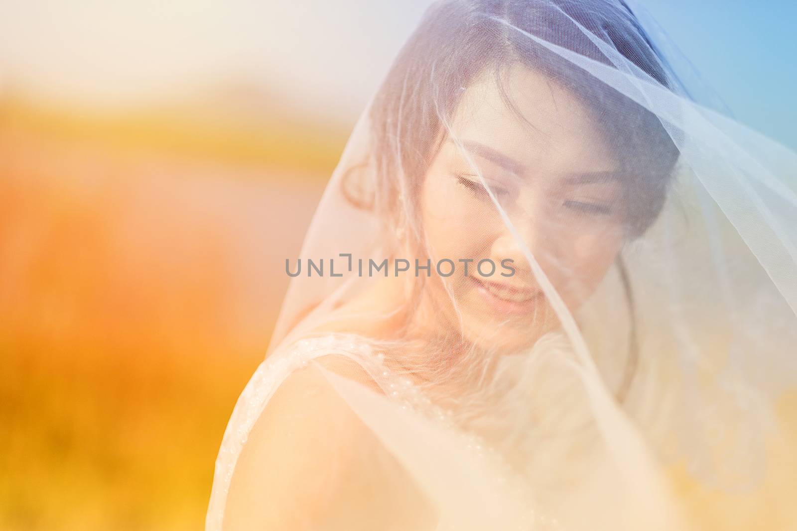 Woman smiling with perfect smile in Veil and sunlight by Surasak